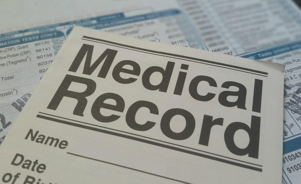 Folders of medical records on a shelf